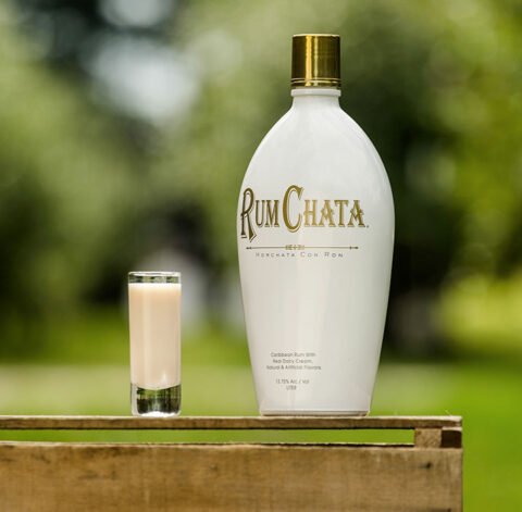 A shot of go-nuts and a bottle of Rumchata outside on a wooden crate