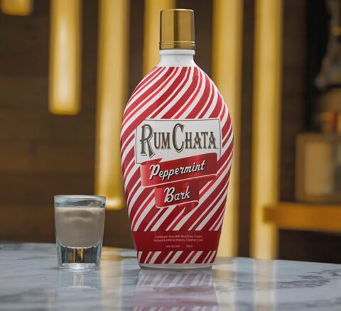 A shot of Rumchata peppermint bark and a bottle on a marble bar table