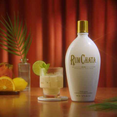 A spiced Mai tai drink beside a Rumchata bottle.